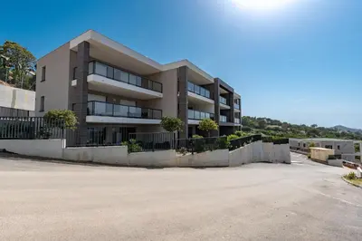 an empty parking lot in front of a building at L'étincelle de Stagnola - Vue mer in Pietrosella