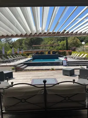 a view of a swimming pool with a white ceiling at Les Jardins De Santa Giulia - Charmante chambre dhte 1 in Porto-Vecchio