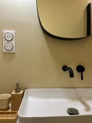 a bathroom with a sink and a mirror and a tub at studio d'architecte superieur - centre ville historique in Ajaccio