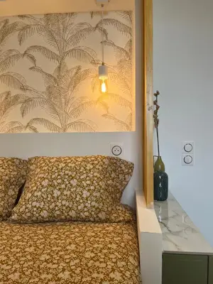 a bedroom with a bed with a wall at studio d'architecte superieur - centre ville historique in Ajaccio