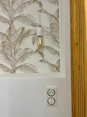 a bathroom with a wall with a drawing of leaves at studio d'architecte superieur - centre ville historique in Ajaccio