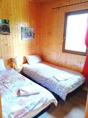 a bedroom with two beds and a window at Chalet de Santa in Corte