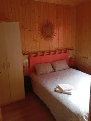 a bedroom with a bed with a mirror on the wall at Chalet de Santa in Corte