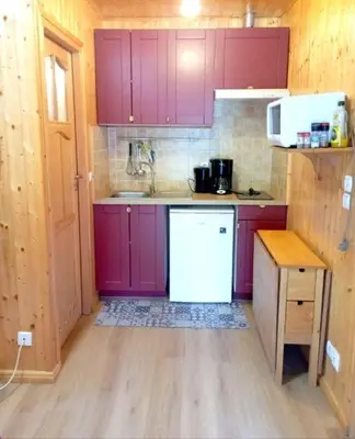 a kitchen with purple cabinets and a white refrigerator at Chalet de Santa in Corte
