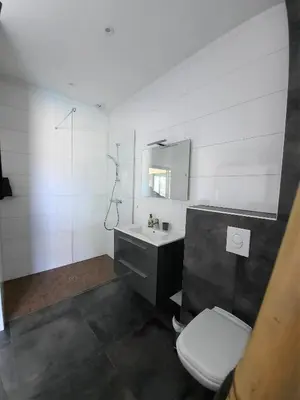 a white bathroom with a toilet and a sink at Villa Cupabia vue mer in Viggianello