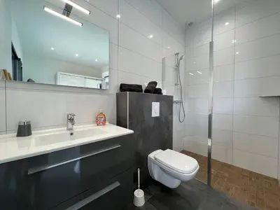 a bathroom with a toilet and a sink and a shower at Villa Cupabia vue mer in Viggianello