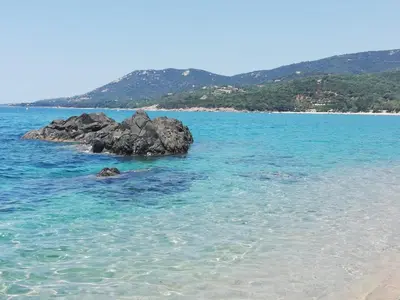 a group of rocks in the water on a beach at Villa Cupabia vue mer in Viggianello