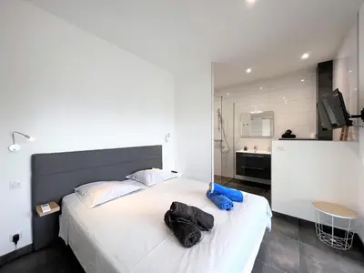 a bedroom with a large white bed with towels on it at Villa Cupabia vue mer in Viggianello
