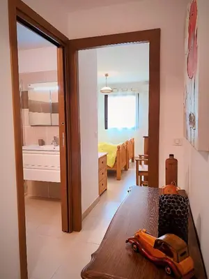 a bedroom with a toy car on a wooden table at PORTO PIANO 2 pièces en centre-ville in Propriano