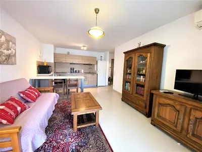 a living room with a couch and a table at PORTO PIANO 2 pièces en centre-ville in Propriano