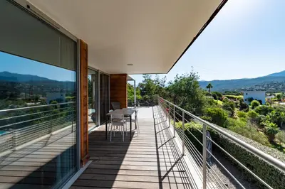 a balcony of a house with a table and chairs at Via Mare - Apt avec splendide vue in Grosseto-Prugna