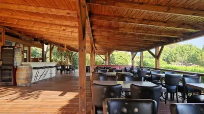 a dining room with tables and chairs on a wooden deck at Mare E Monti in Porto Pollo