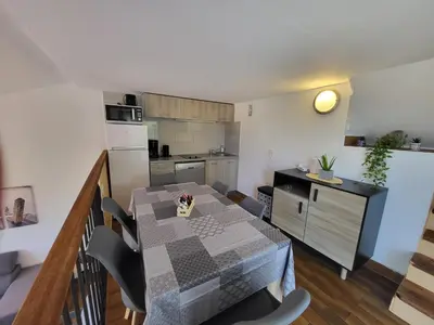 a kitchen and dining room with a table and chairs at PORTICCIO villa dans résidence avec piscines 4-6 personnes BRILOC Appartements in Porticcio