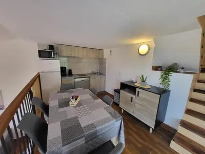 a kitchen and dining room with a table and chairs at PORTICCIO villa dans résidence avec piscines 4-6 personnes BRILOC Appartements in Porticcio