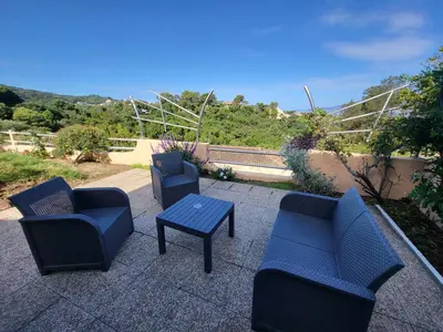 a group of chairs and a table on a patio at PORTICCIO villa dans résidence avec piscines 4-6 personnes BRILOC Appartements in Porticcio