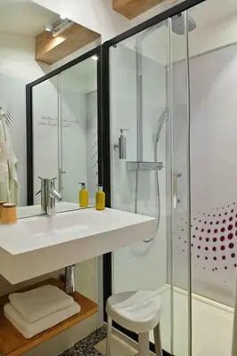 a bathroom with a sink and a shower at Hôtel Domaine A Flatta in Calenzana