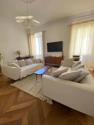 a living room with two couches and a flat screen tv at Appartement de maître T3 80m2 en plein centre. in Ajaccio
