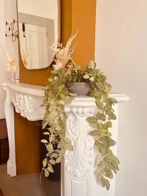 a white console table with a wreath on it at Appartement de maître T3 80m2 en plein centre. in Ajaccio