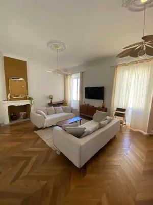 a living room with two couches and a television at Appartement de maître T3 80m2 en plein centre. in Ajaccio