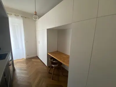 a small kitchen with a wooden table in a room at Appartement de maître T3 80m2 en plein centre. in Ajaccio