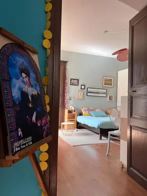 a living room with a painting of a woman at Joli appartement F2 centre ville de Corte in Corte