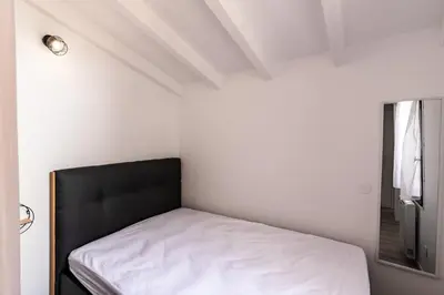 a bed in a small room with a window at Le Paesolu in Grosseto-Prugna