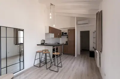 a kitchen with a counter and stools in a room at Le Paesolu in Grosseto-Prugna