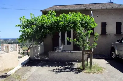 a small tree in front of a house at T2 Casamozza Sud de Bastia climatisé in Monte