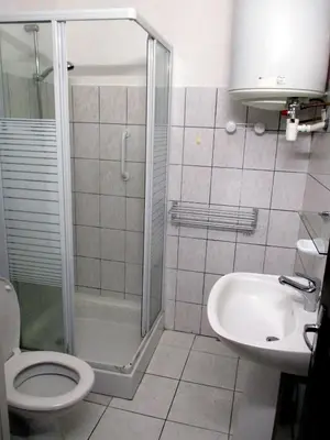 a bathroom with a shower and a toilet and a sink at T2 Casamozza Sud de Bastia climatisé in Monte