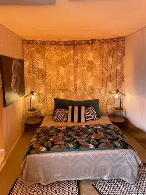 a bedroom with a large bed with two lamps at FORCONE in Cauro