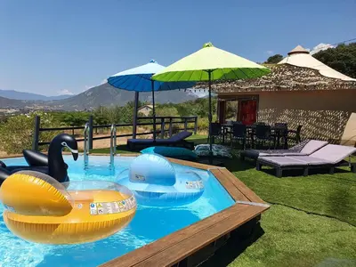 a pool with two inflatable boats in the water at FORCONE in Cauro