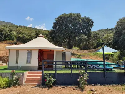 a small house with a gazebo and a table at FORCONE in Cauro