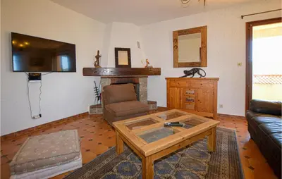a living room with a couch and a coffee table at Cozy Apartment In Porticcio With Wifi in Porticcio