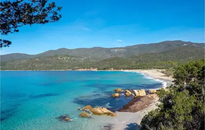 a view of a beach with mountains in the background at Cozy Apartment In Porticcio With Wifi in Porticcio