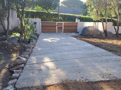 a gravel road with a tree and some plants at Edith et Jean-Paul in Porto-Vecchio