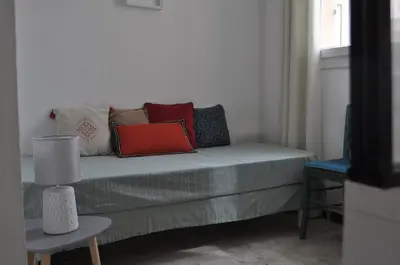 a couch with pillows on it in a living room at Appartement duplex plein sud sur le port de Bonifacio in Bonifacio