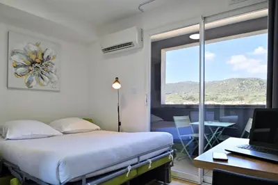 a hospital room with a bed and a desk with a laptop at Résidence Easy Lodge in Ajaccio