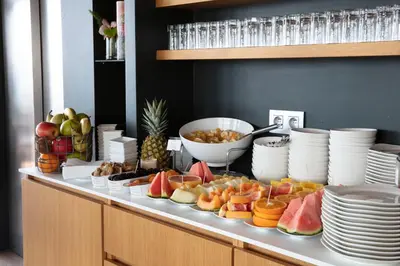 a buffet with a variety of fruit on a table at Hotel Alcyon in Porto-Vecchio
