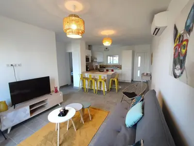 a living room with a couch and a table at Olmeto 3 pièces in Olmeto