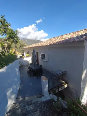 a patio of a house with a table at Olmeto 3 pièces in Olmeto