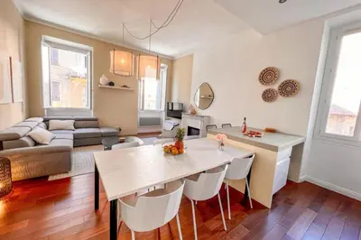 a kitchen and living room with a couch and a table at Alba - Central Glimpse of the sea Sea nearby in Ajaccio