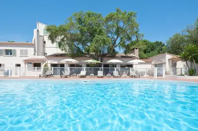 a large swimming pool in front of a building at Résidence Domaine De Caranella in Porto-Vecchio