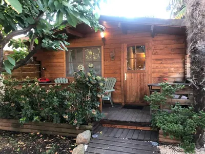 a patio with two chairs and a couch at Chalet - Piscine - Wifi in Penta-di-Casinca