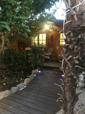 a garden with a stone path and a house at Chalet - Piscine - Wifi in Penta-di-Casinca