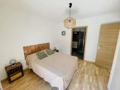 a bedroom with a bed and a wooden floor at Ajaccio T2 grand standing neuf - centre ville et plages - 4 personnes - parking privé in Ajaccio