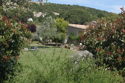 a garden with a house in the background at Les Jardins De Santa Giulia - Charmante chambre dhte in Porto-Vecchio