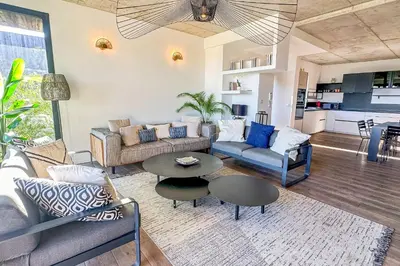 a living room with a couch and a table at Villa Santa Lucia Di Fautea in Sainte-Lucie de Porto-Vecchio
