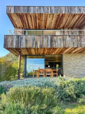 a house on a hill with a wooden roof at Villa Santa Lucia Di Fautea in Sainte-Lucie de Porto-Vecchio