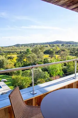 a view from the balcony of a house with a table and chairs at Villa Santa Lucia Di Fautea in Sainte-Lucie de Porto-Vecchio