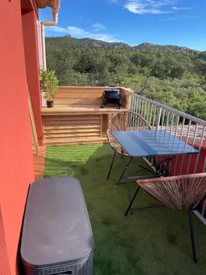 a patio with a table and chairs on a balcony at Chez Jeff Lucchini in Lecci